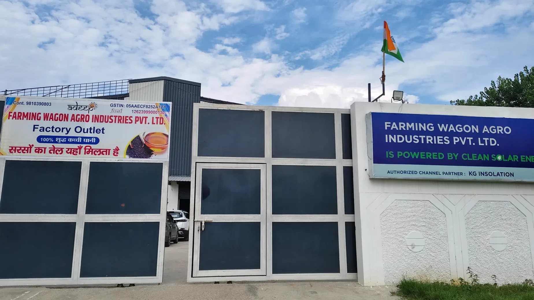 The plant gate at Village Gummawala, with the factory outlet board